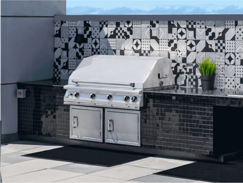 large 48" inch grill in a black outdoor island in front of a stylish tile backsplash